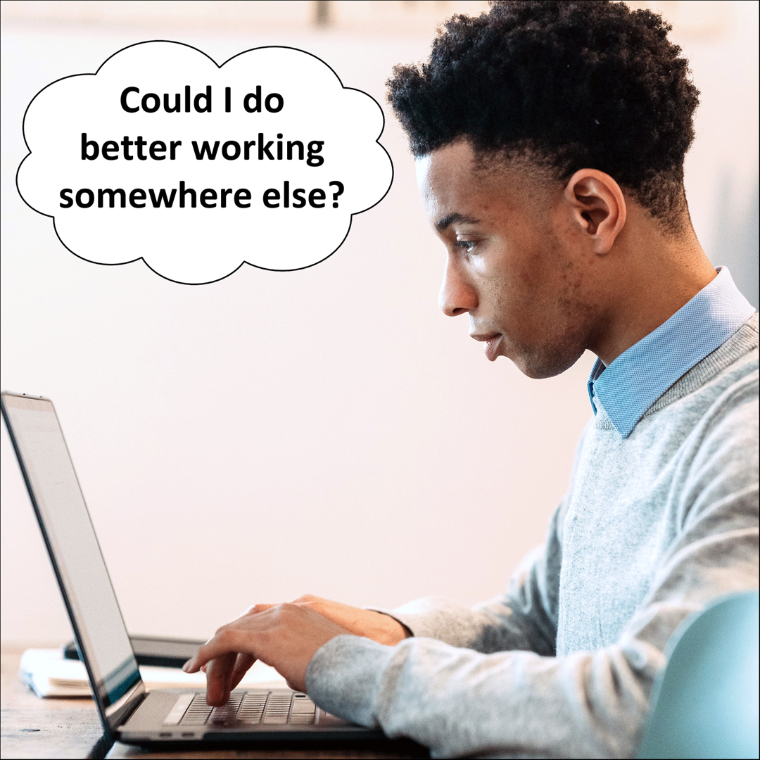 Young African-American man looking at laptop thinking "Could I do better working somewhere else?"